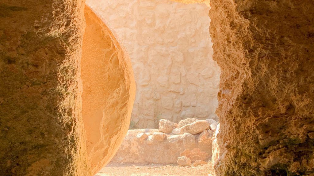 There is a large rock in the middle of a cave.