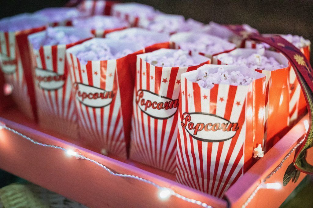 A box of popcorn is sitting on a table.
