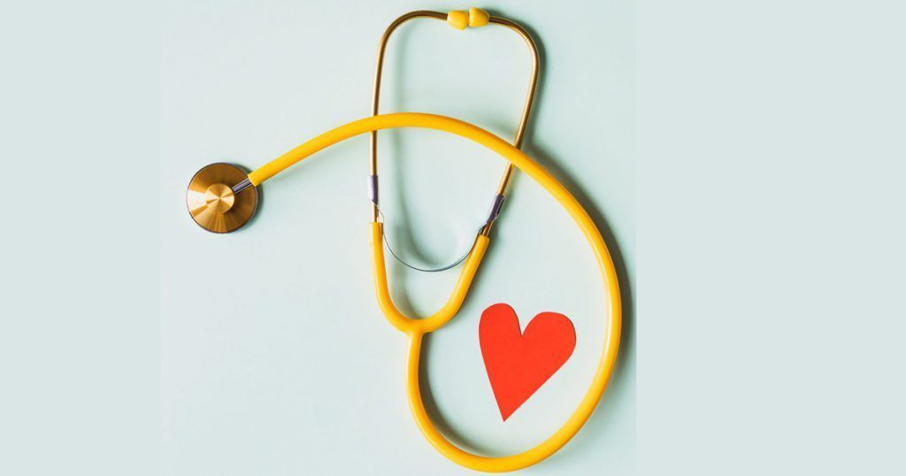 A yellow stethoscope with a red heart on it.