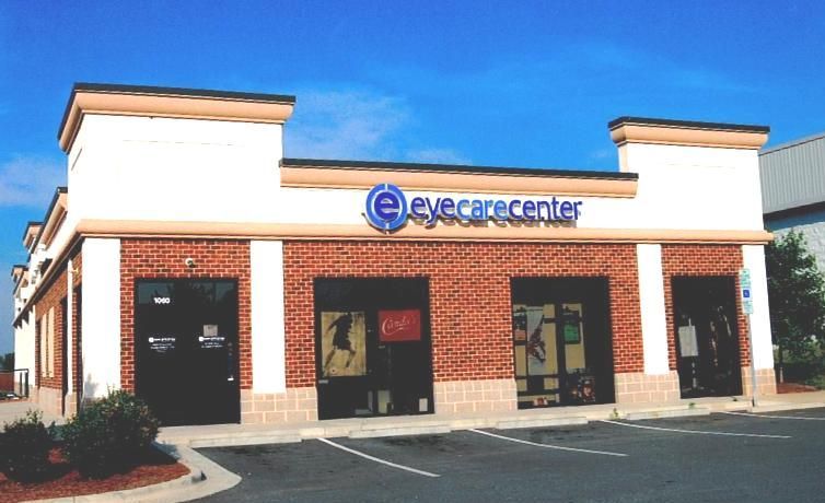 Eyecare Center storefront with white and brick exterior under a blue sky
