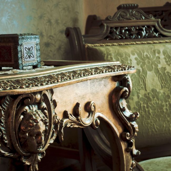 A carved table with a lion 's head on it