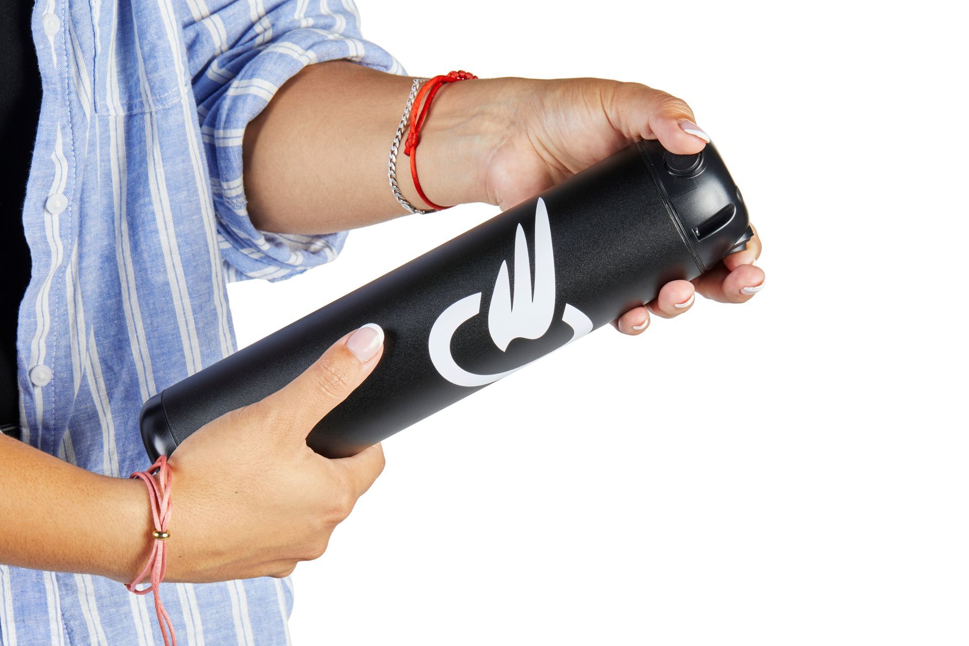 Hands holding a black cylindrical object with white Arabic lettering on a white background