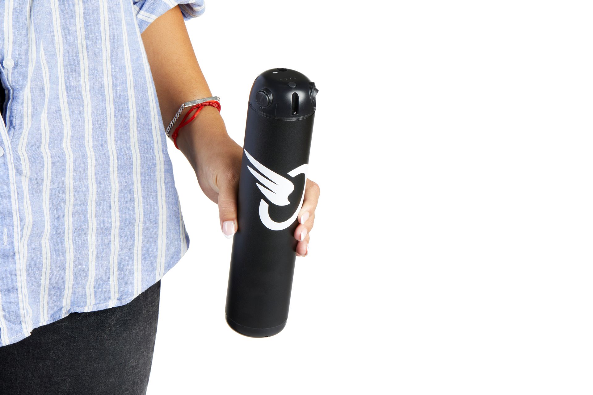 Person holding a black cylindrical bottle with a white logo against a white background