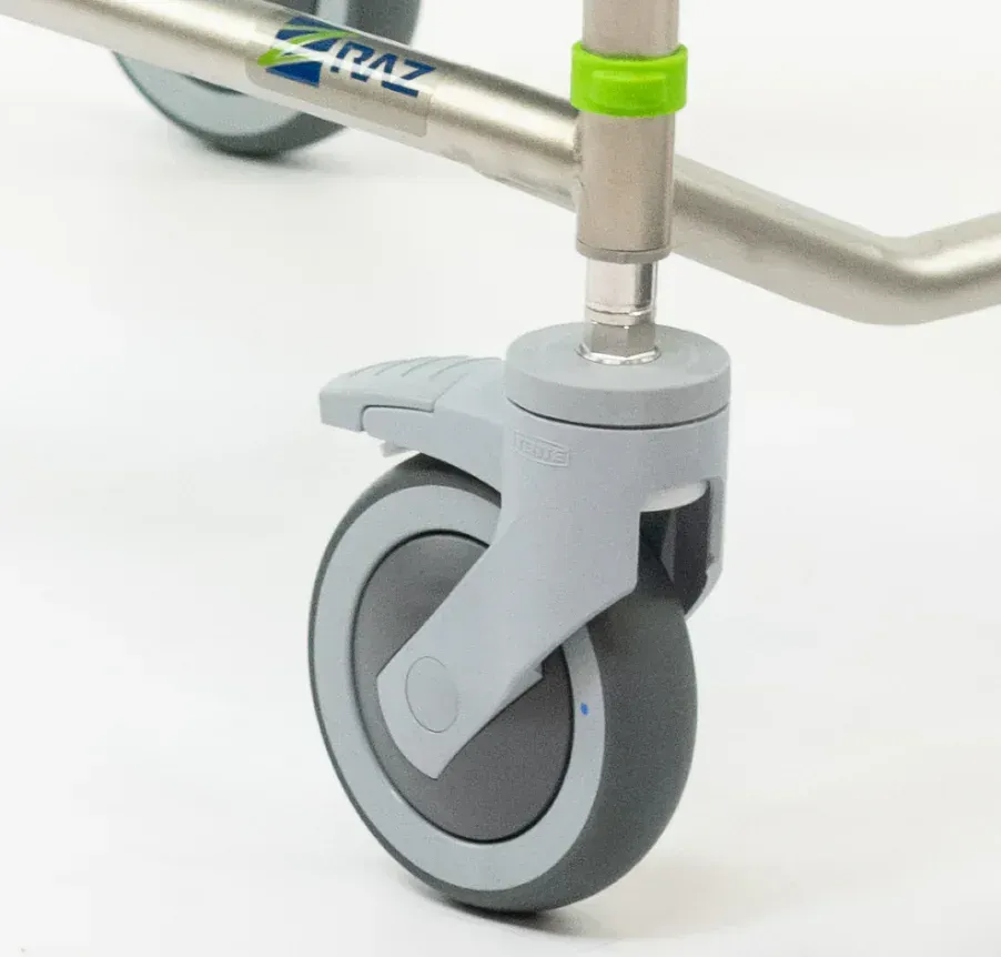 Close-up of a wheelchair front wheel with grey frame and tire, with the
