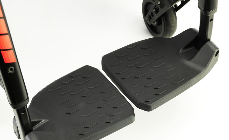 Black wheelchair footrests with textured surfaces.