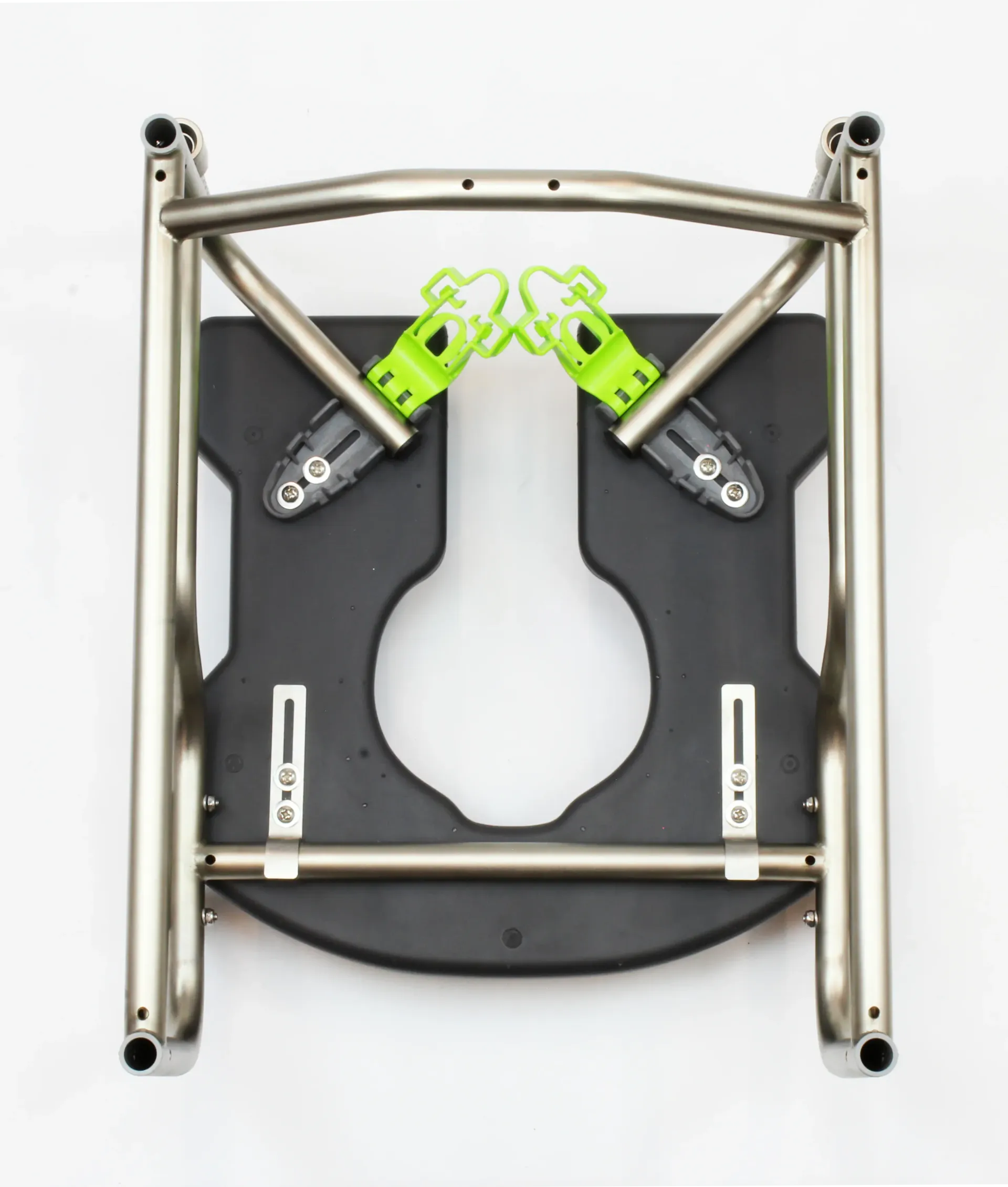 Wheelchair footrest frame with black seat and green foot supports, on white.