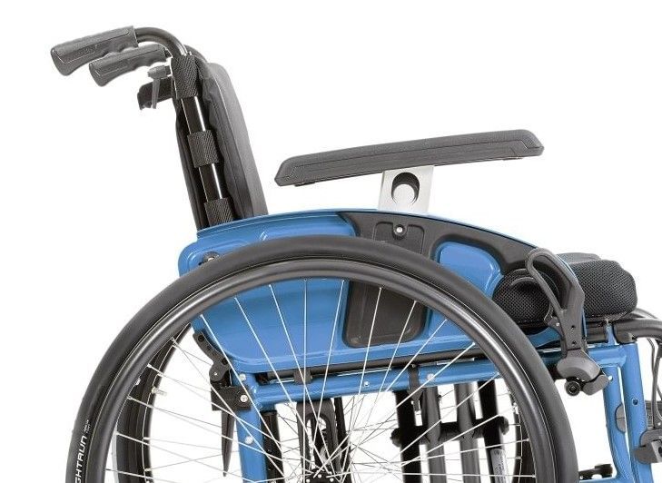 Blue wheelchair, side view, with armrest, black wheel, and back support.