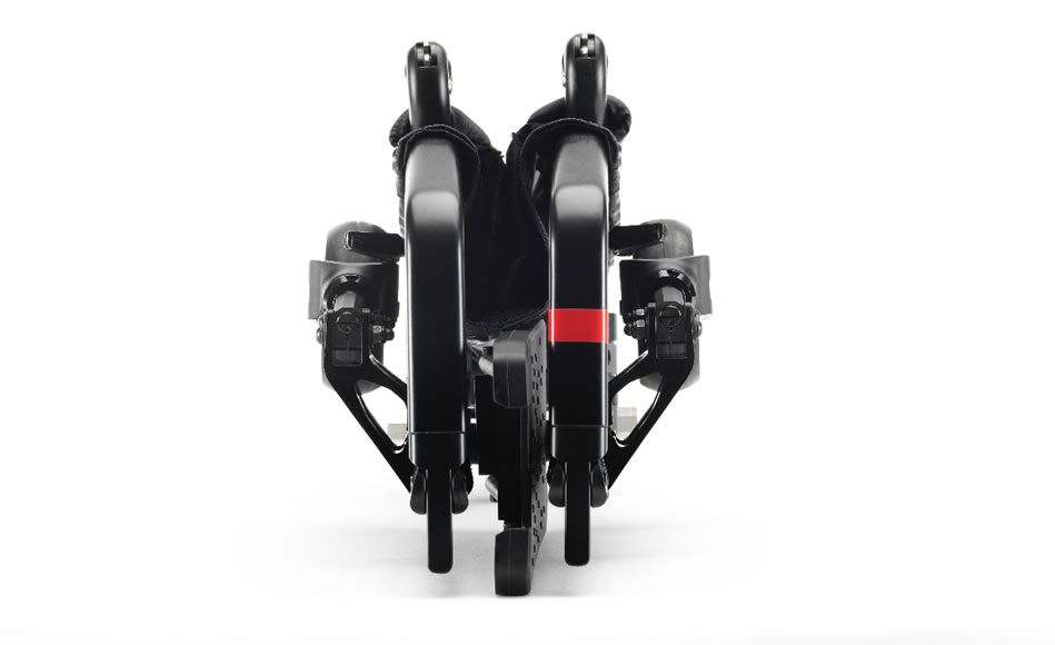 Folded black wheelchair on a white surface, viewed from the front.
