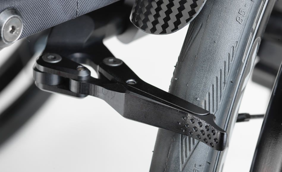 Black wheelchair lever and tire close-up.