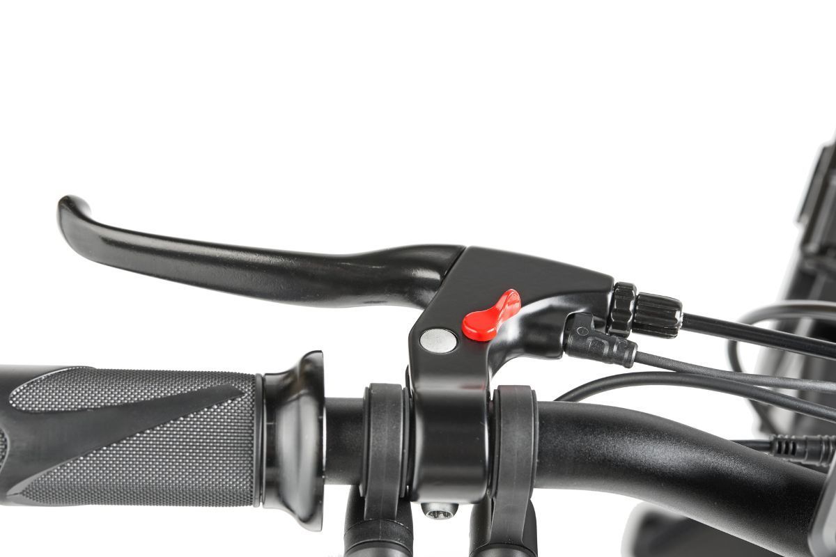 Black bicycle brake lever on a black handlebar with a red button.