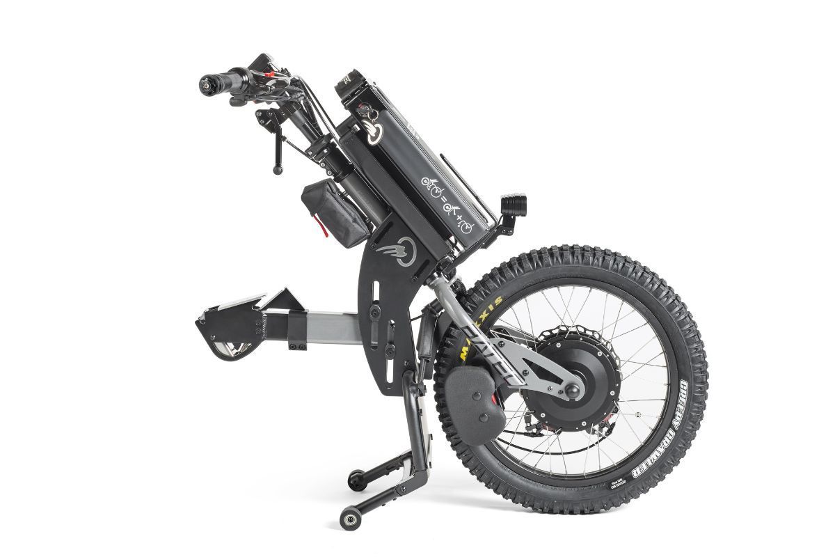 Off-road power wheelchair, black and gray, with large rear wheel, battery pack, and control handles.