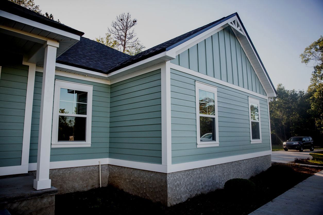 Light blue house exterior with white trim and a steep gabled roof