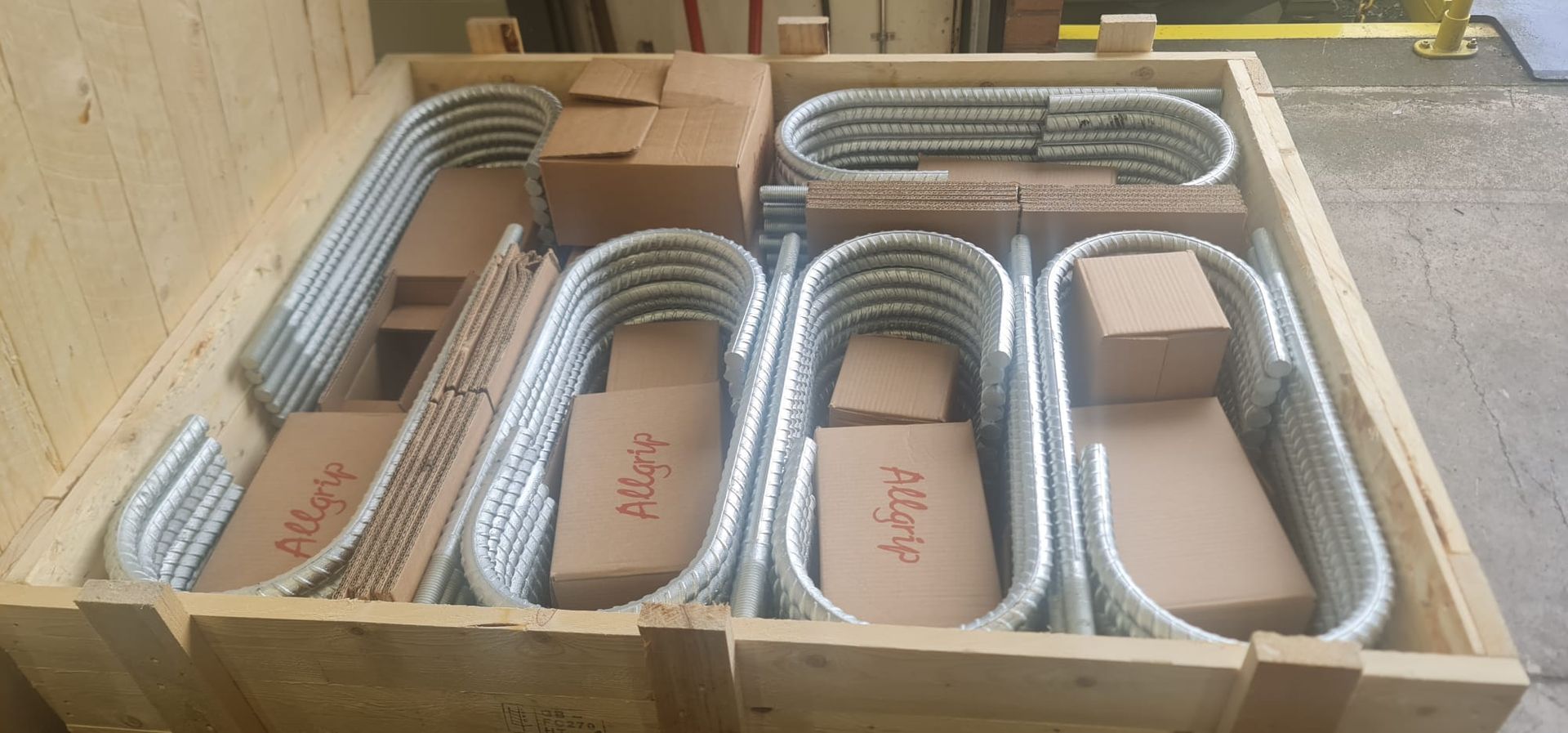 A wooden box filled with metal pipes and boxes