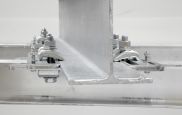 A close up of a metal beam with nuts and bolts attached to it.