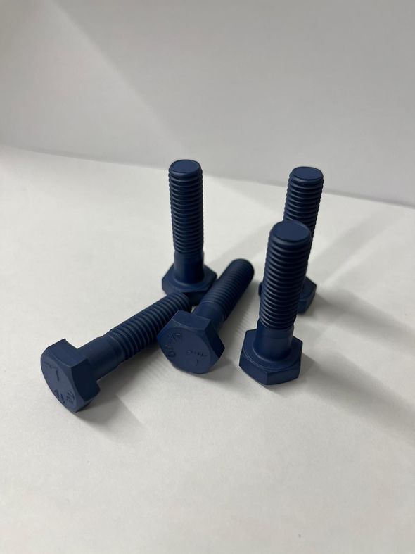 A group of blue bolts are sitting on a white surface.