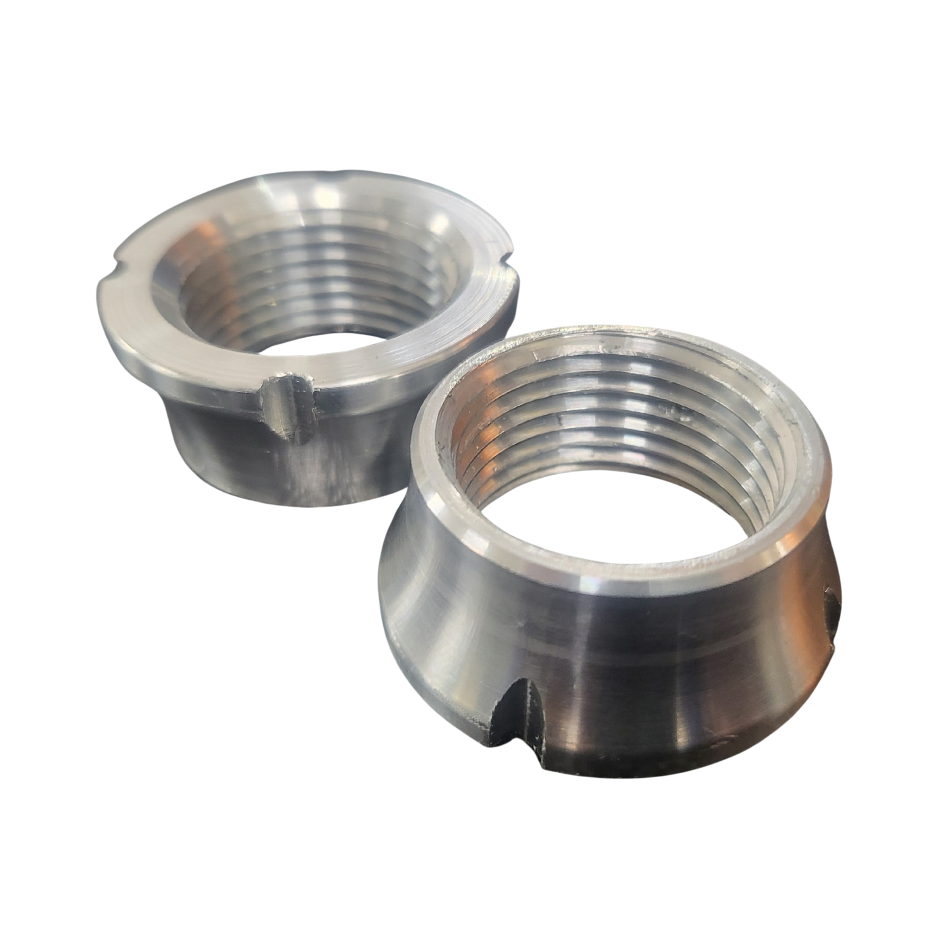 Two metal nuts are sitting next to each other on a white background.