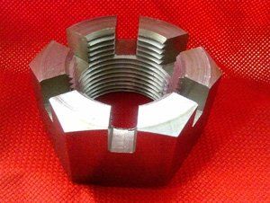 A metal nut is sitting on a red cloth