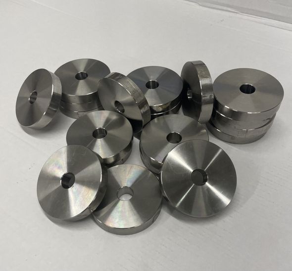 A pile of stainless steel washers with holes in them