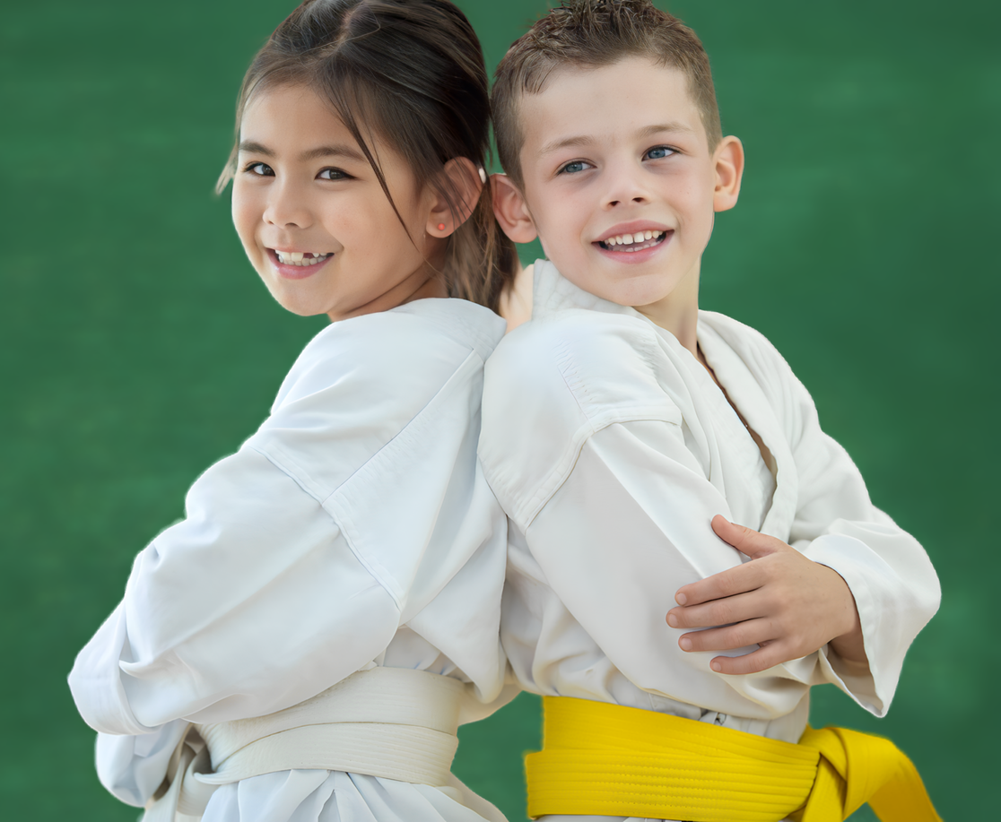 A boy and a girl are standing back to back and smiling