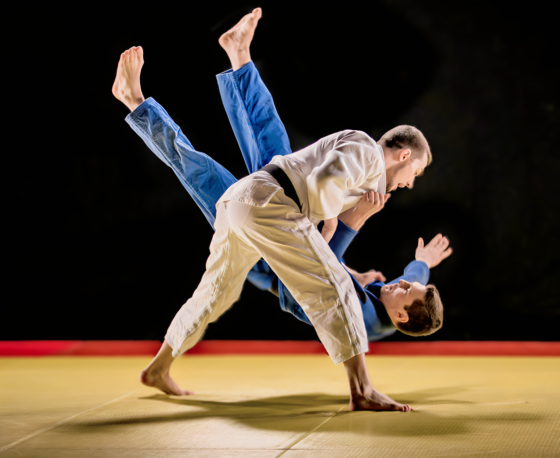 Two men are practicing judo on a mat.