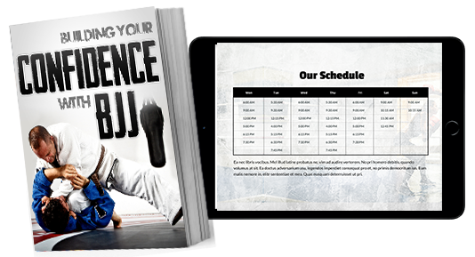 A book titled building your confidence with bjj is next to a tablet.
