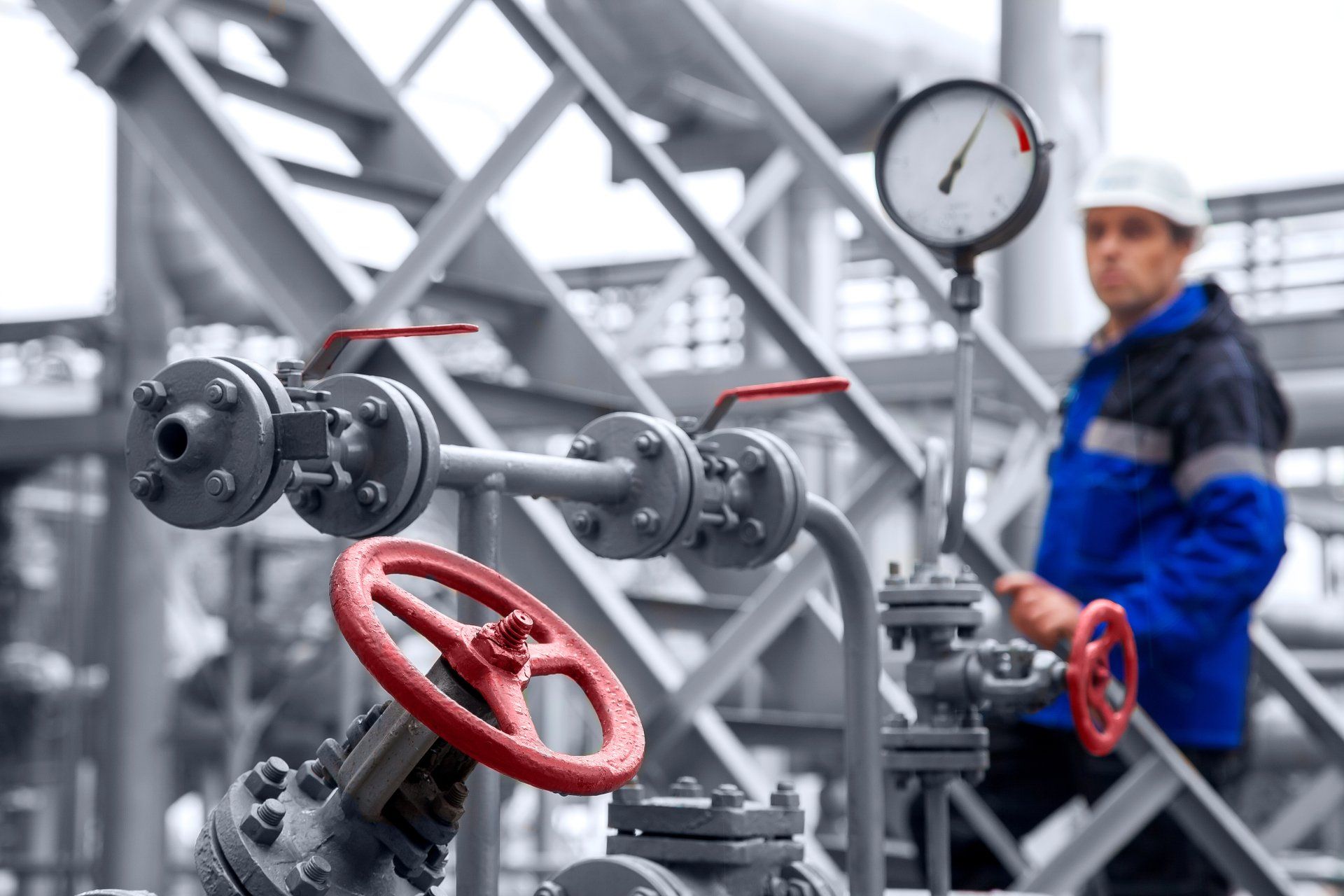 The-oil-refinery--the-worker-in-a-difokus-checks-the-indication-of-a-monometer-and-examines-gates-and-valves