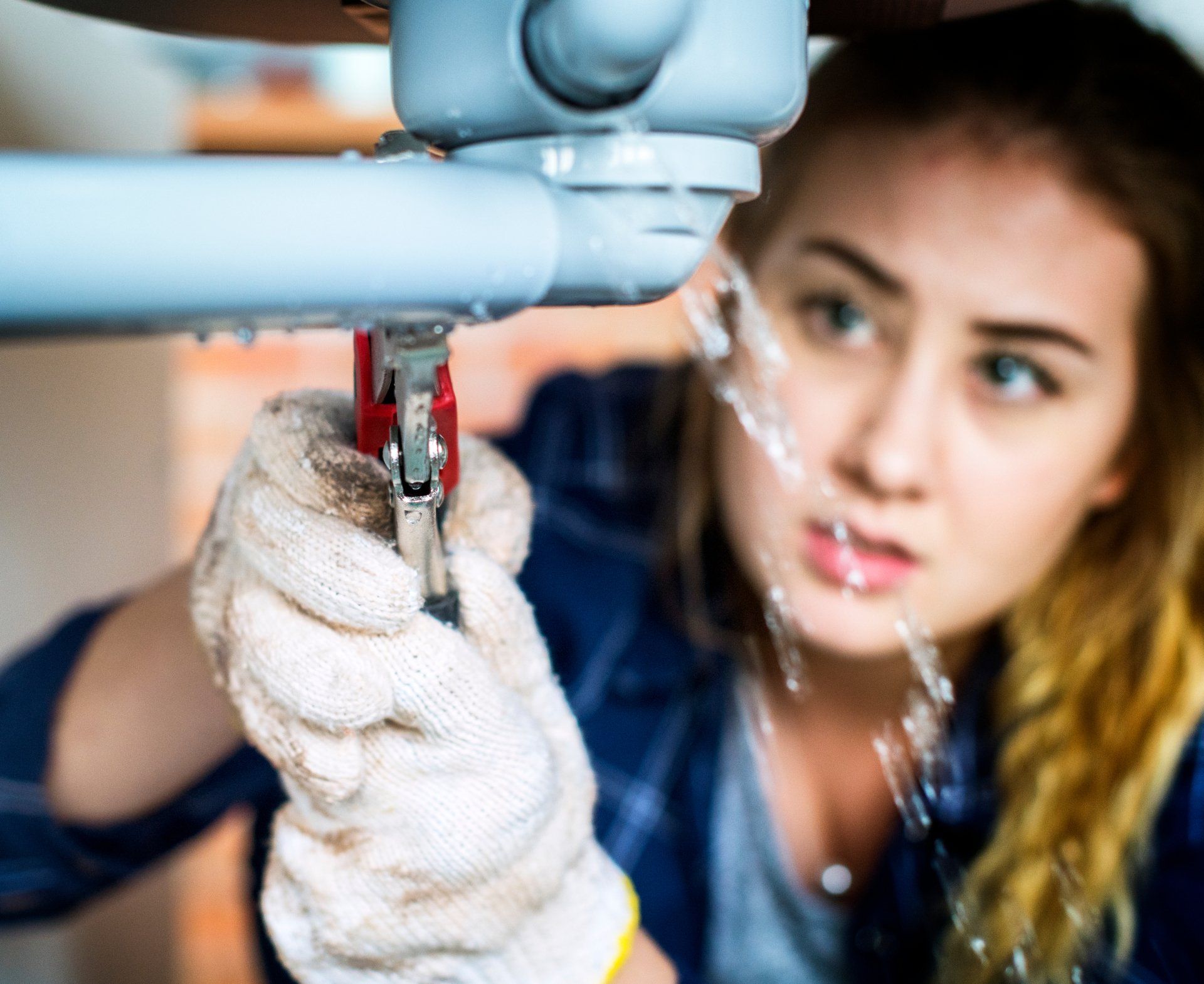 Woman-fixing-kitchen-sink