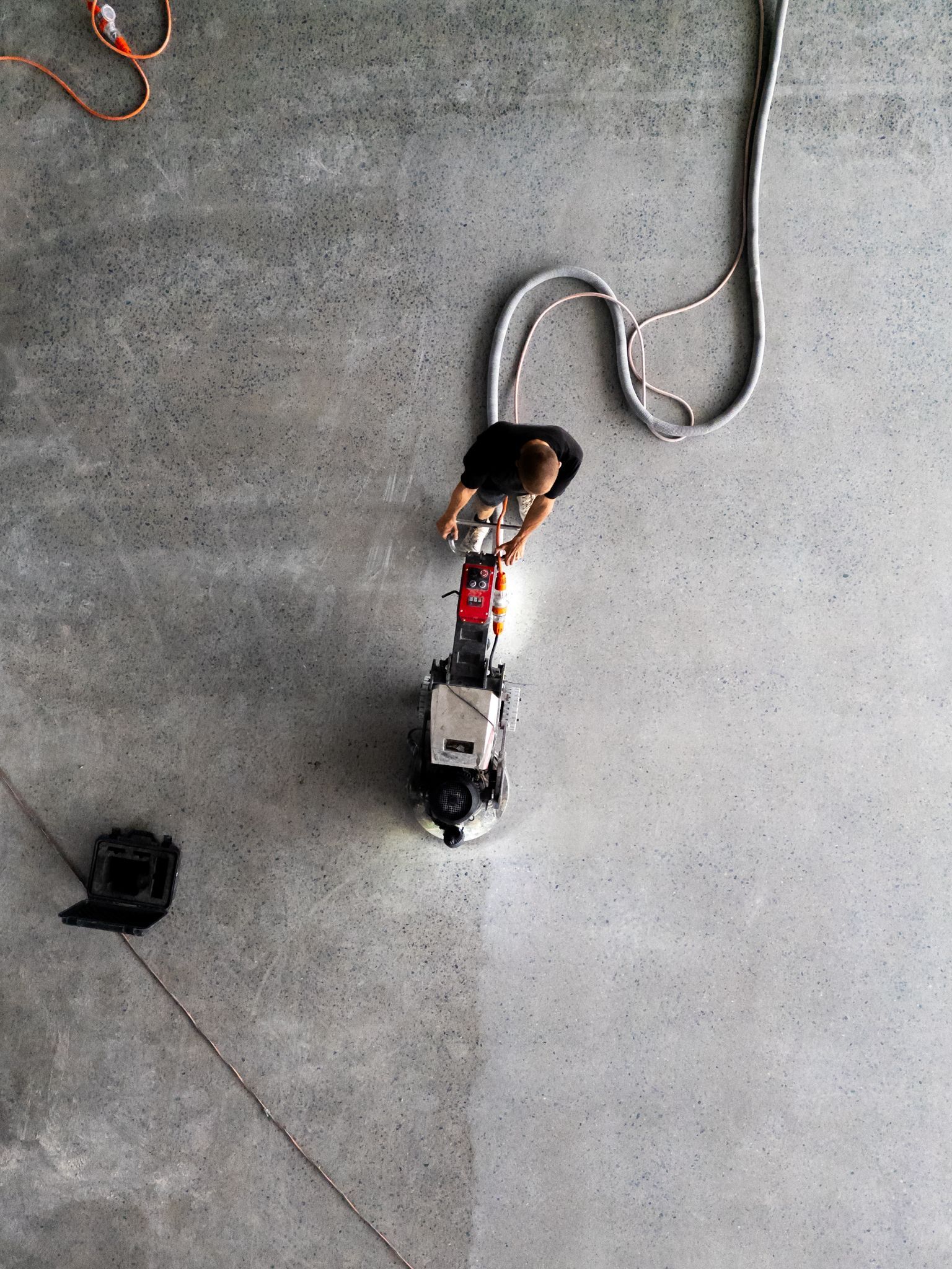Power Strip Plugged Into an Extension Cord on a Concrete Floor — All Grind & Coat in Cairns, QLD