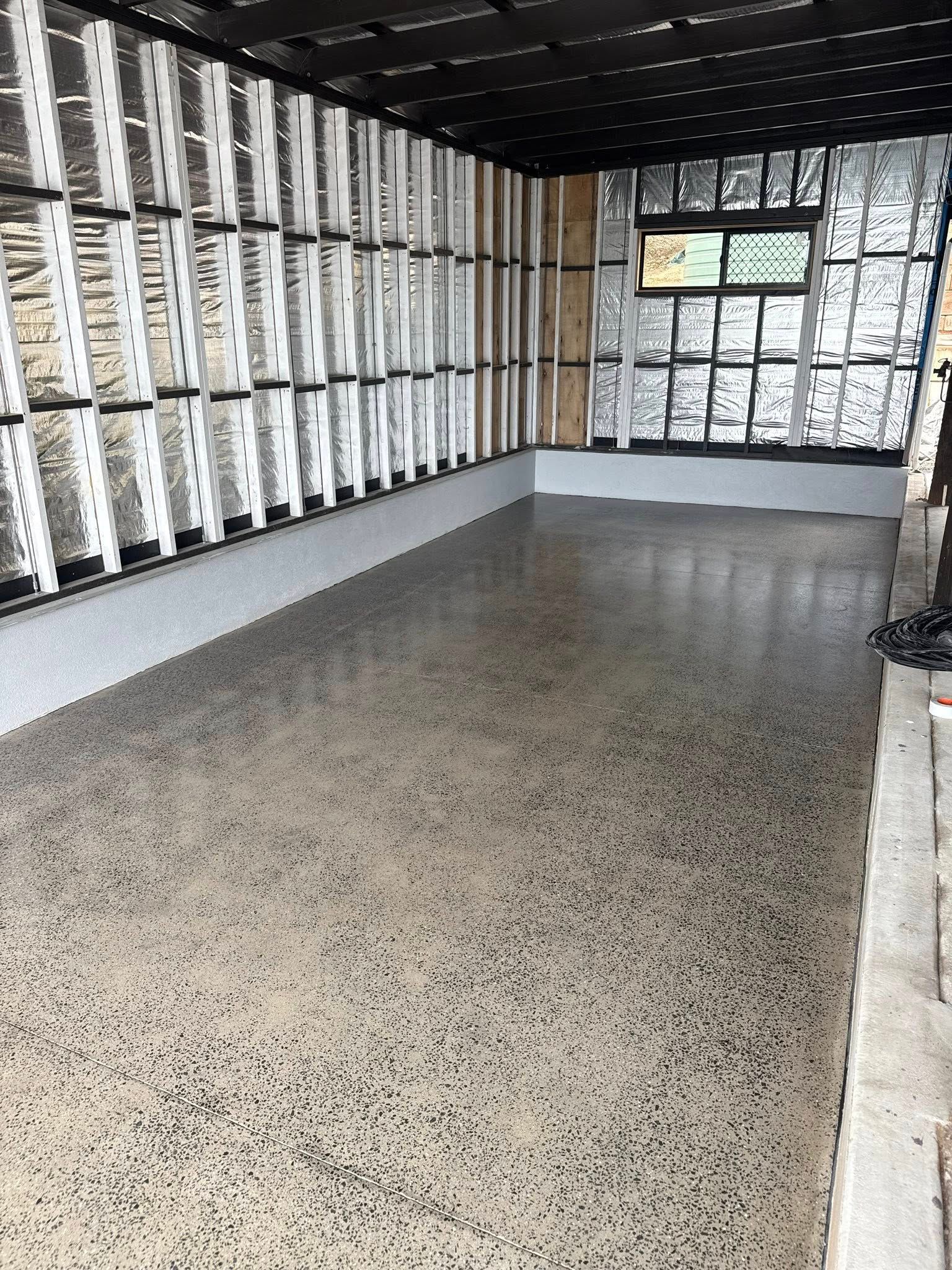 Empty Room With Speckled Floor, Walls Lined With White Mail Slots — All Grind & Coat in Cairns, QLD