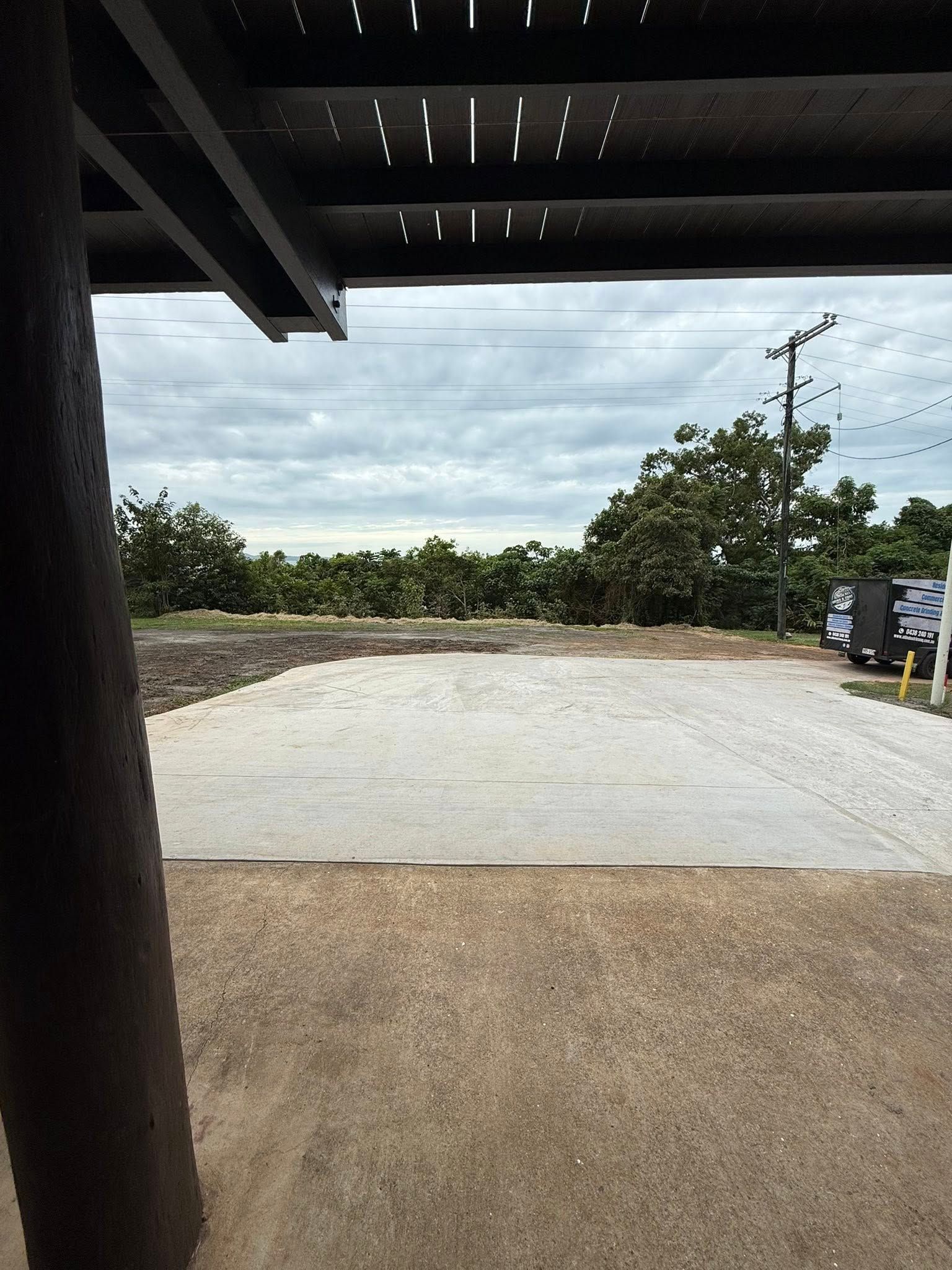 A Concrete Grinder on the Concrete Floor of a Open Garage — All Grind & Coat in Cairns, QLD