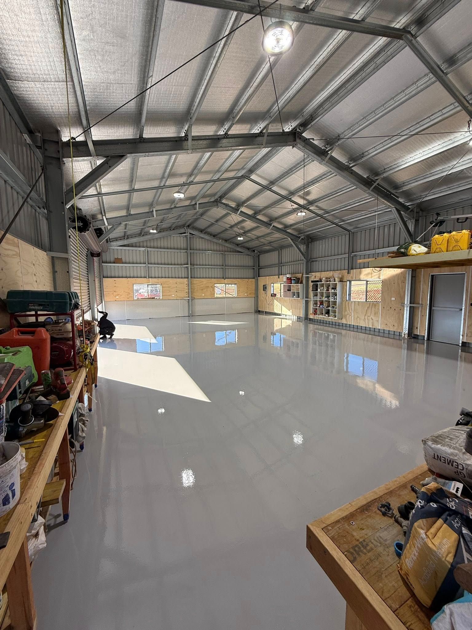 Empty Warehouse With a Shiny Concrete Floor — All Grind & Coat in Cairns, QLD