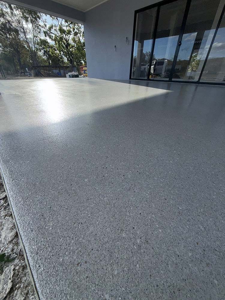 Polished Grey Concrete Patio With a Glossy Finish — All Grind & Coat in Cairns, QLD 
