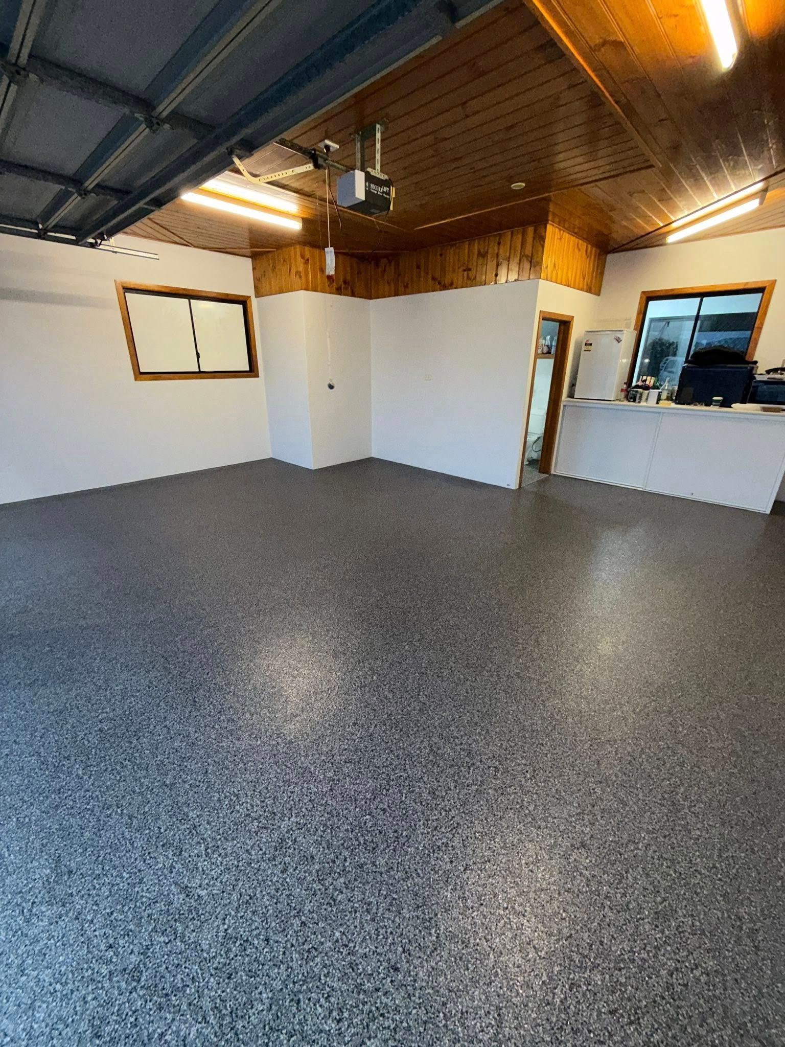 Empty Industrial Room With Speckled Floor — All Grind & Coat in Tablelands, QLD