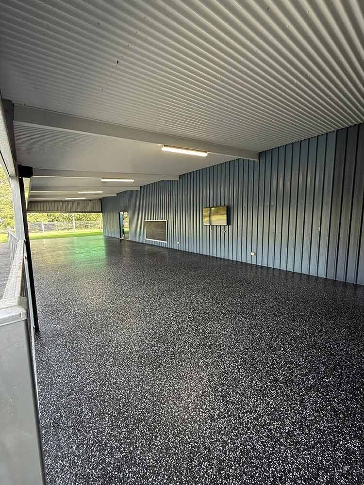 Long, Open Shelter With Grey Corrugated Ceiling — All Grind & Coat in Cairns, QLD