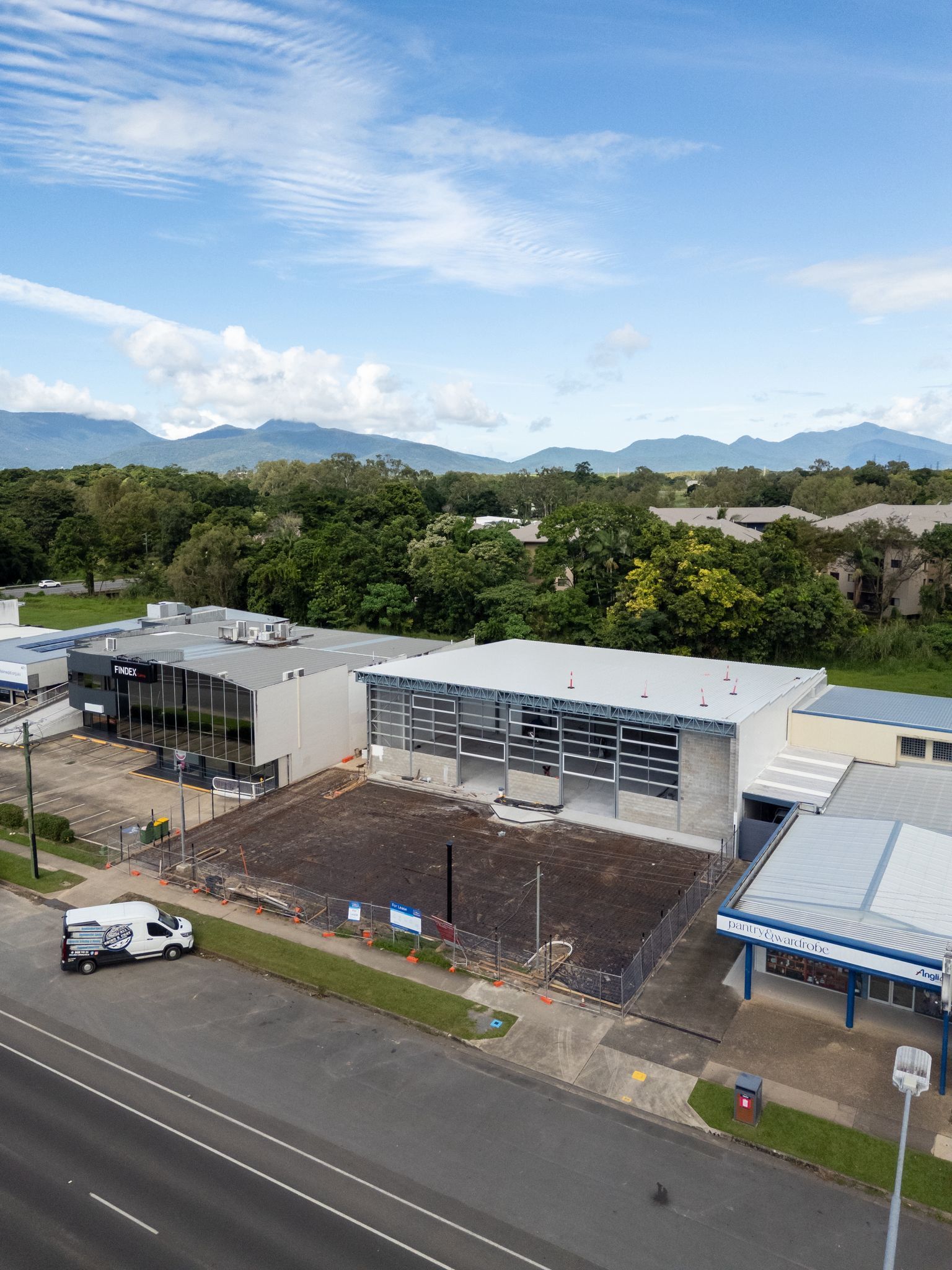 Empty Warehouse Interior With Shiny White Floor — All Grind & Coat in Cairns, QLD
