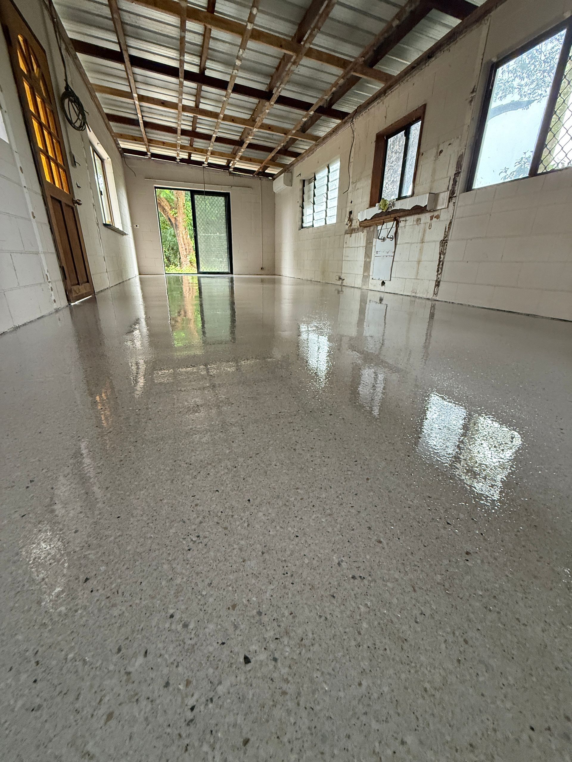 Polished Concrete Floor Reflects Windows and Interior of Room — All Grind & Coat in Cairns, QLD