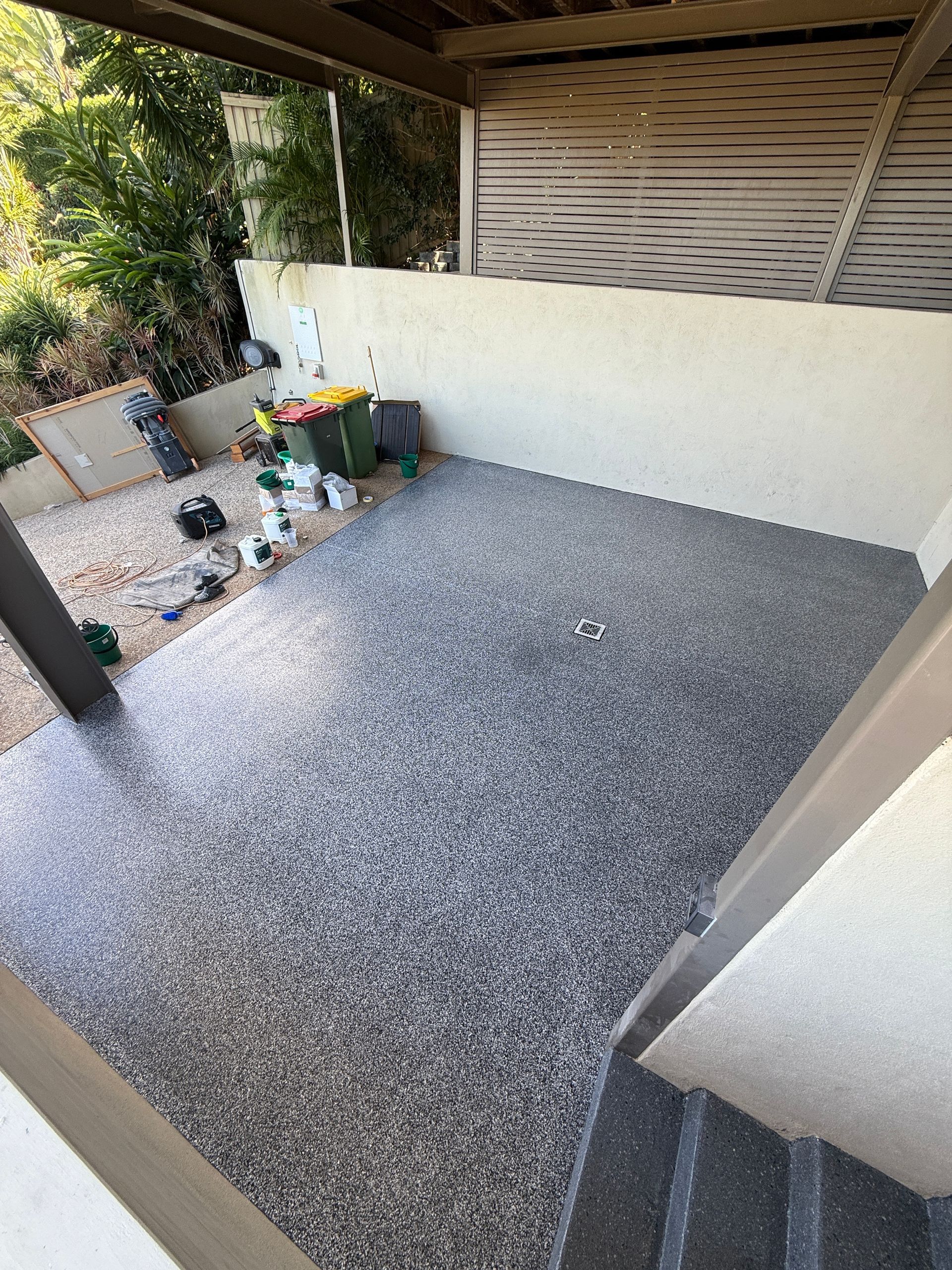 Patio With Grey Speckled Flooring, Beige Walls, and a Wooden Pergola — All Grind & Coat in Cairns, QLD