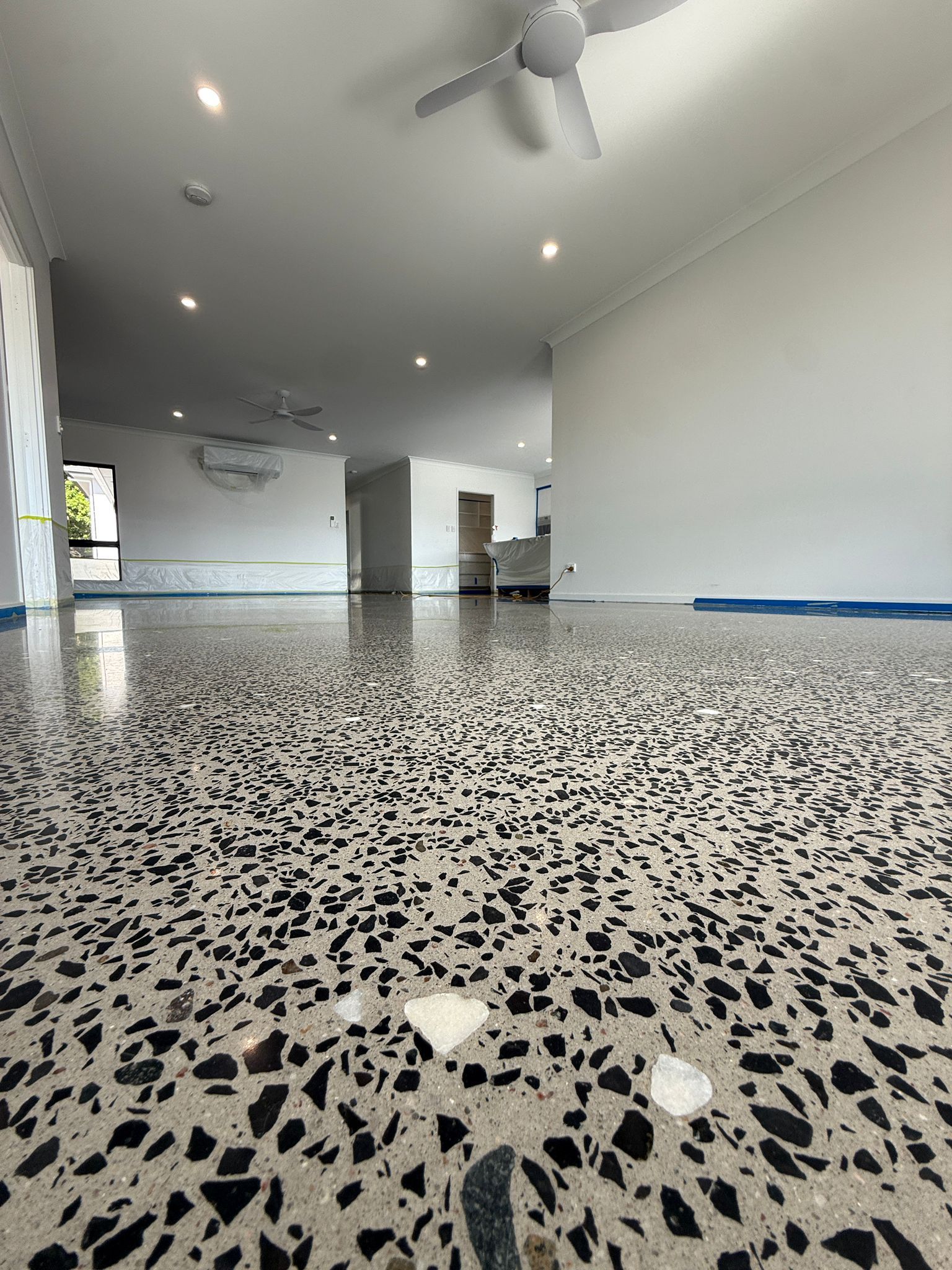 Empty Modern Room With Speckled Terrazzo Floor — All Grind & Coat in Cairns, QLD