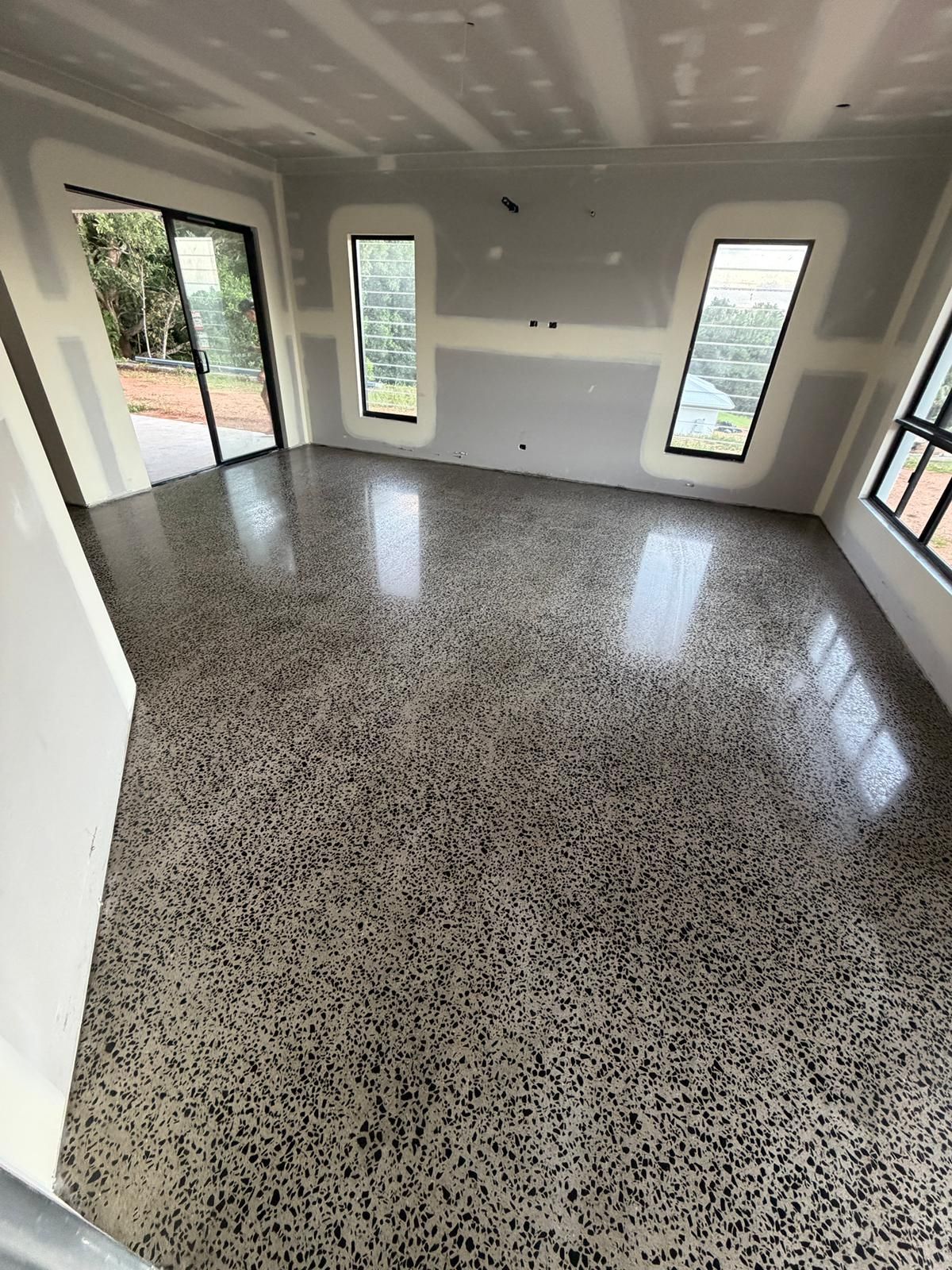 Empty Modern Room With Speckled Terrazzo Floor — All Grind & Coat in Cairns, QLD