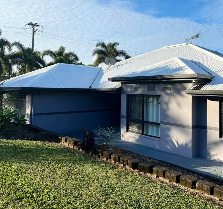Single-story House With White Roof, Grey Garage, and Green Lawn in Bright Daylight — All Grind & Coat in Cairns, QLD