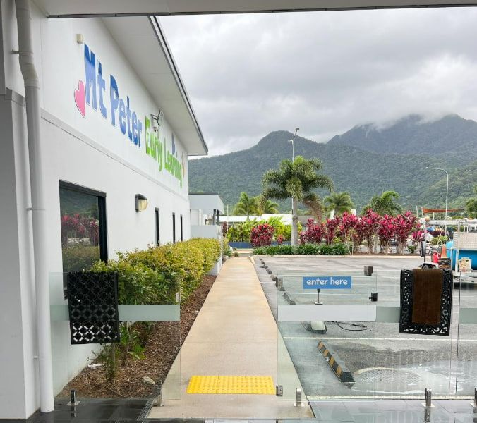 Modern Office Walkway With Yellow Tactile Paving, Greenery — All Grind & Coat in Cairns, QLD