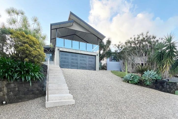A Modern House With a Large Garage and Stairs Leading Up to It — All Grind & Coat in Cairns, QLD