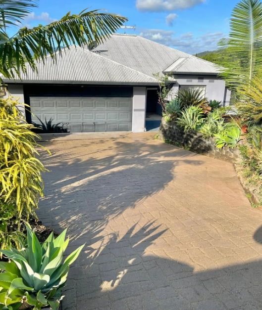 A Driveway Leading to a House With a Garage — All Grind & Coat in Cairns, QLD
