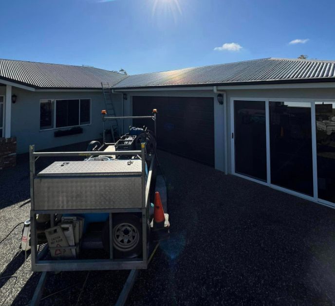 A Trailer is Parked in Front of a House — All Grind & Coat in Cairns, QLD