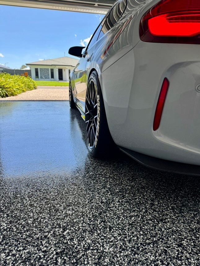 White Car With Black Wheels Parked Inside a Garage — All Grind & Coat in Cairns, QLD