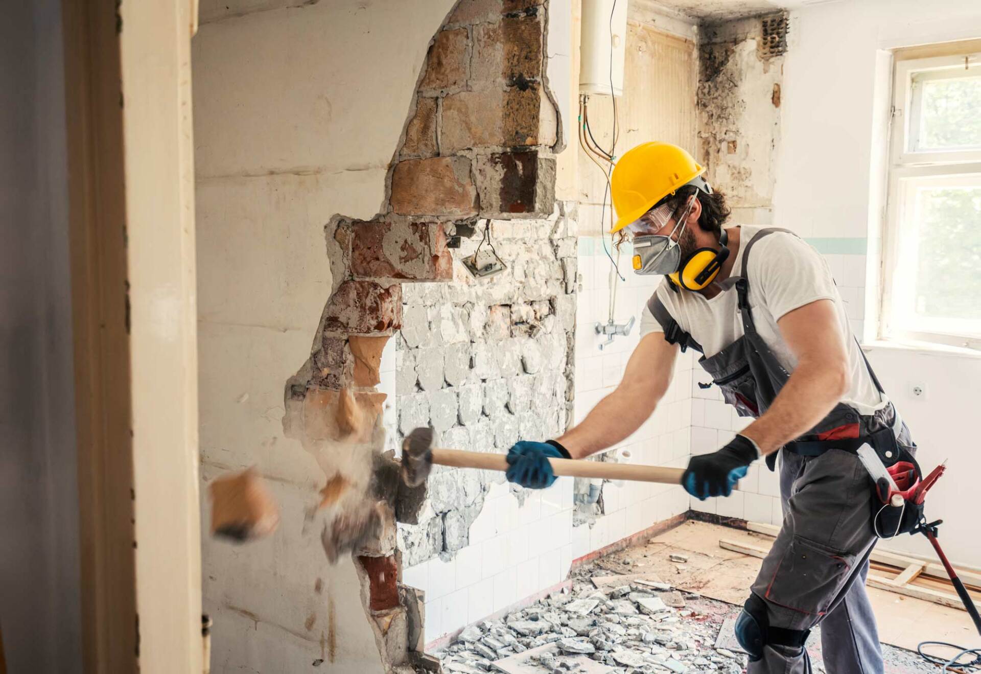 Man demolishing wall | Sydney, NSW | M & M Demolition Pty Ltd