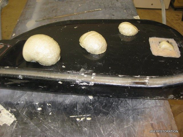 Three balls of dough are sitting on a black surface