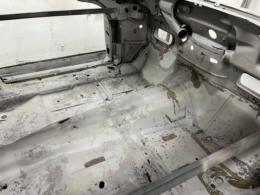 The inside of a car is covered in dust and dirt.