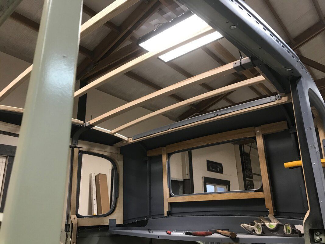 The ceiling of a building is being built with wooden beams.