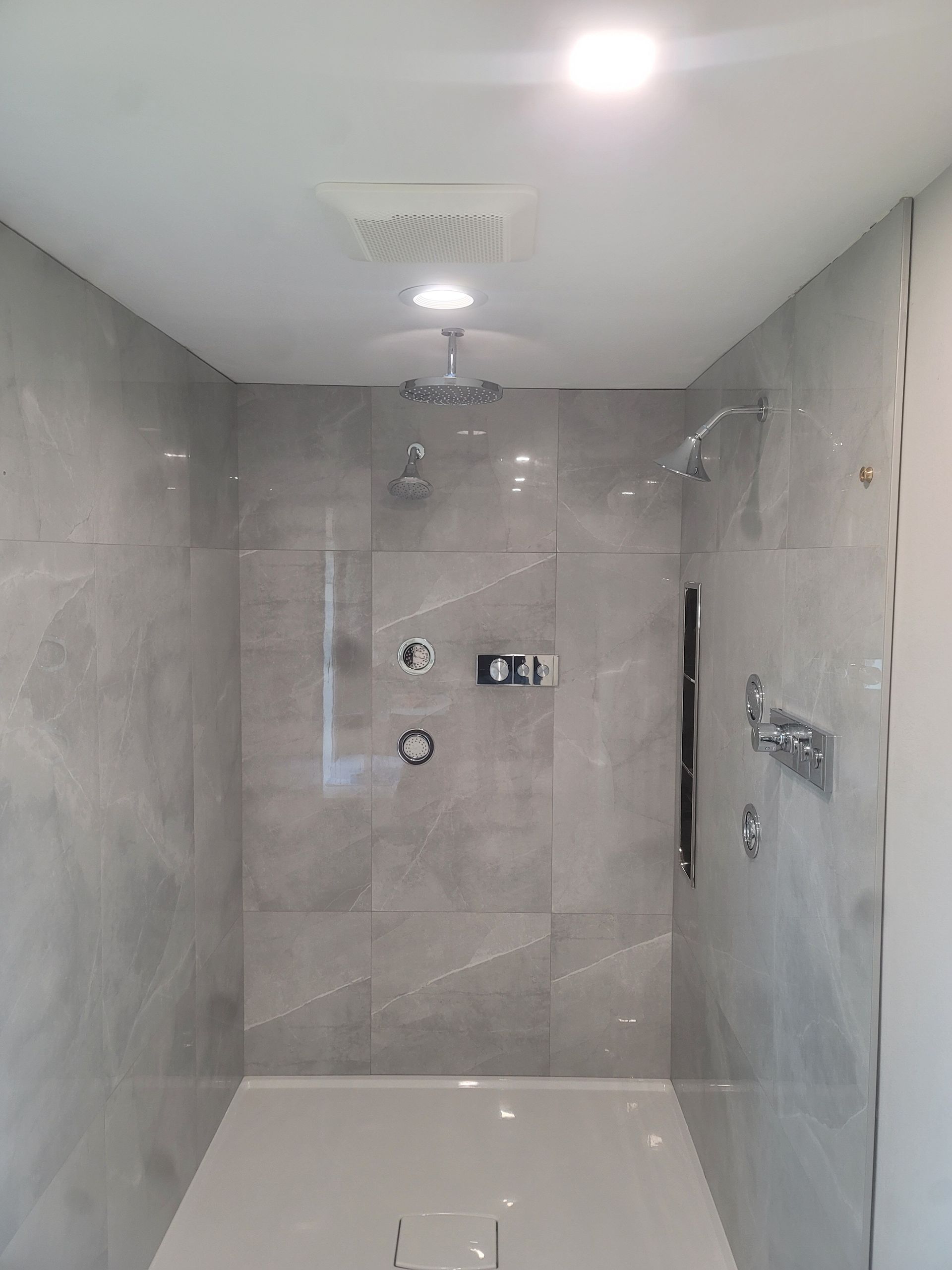 A bathroom with a walk in shower and a bathtub.